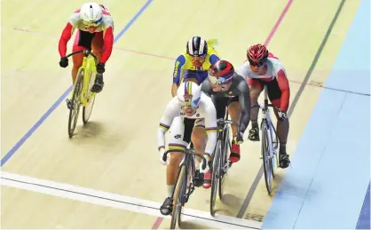  ??  ?? NILAI: Track cycling world champion Azizulhasn­i Awang (white with rainbow) competes during the keirin men final of the 29th Southeast Asian Games (SEA Games) in Nilai, Negeri Sembilan yesterday.