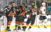  ?? Ashley Landis Associated Press ?? DUCKS teammates crowd around Troy Terry after his first-period goal, one of three he scored.