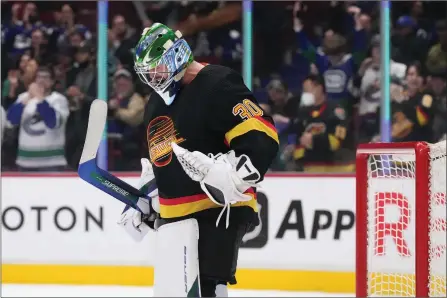  ?? The Canadian Press ?? Vancouver Canucks goalie Spencer Martin celebrates after Vancouver defeated the Seattle Kraken 5-2 during an NHL game in Vancouver on Tuesday. Martin is in line for a promotion next season to become Thatcher Demko’s backup.