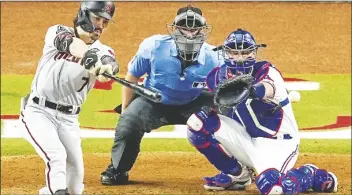  ?? TONY GUTIERREZ/AP ?? ARIZONA DIAMONDBAC­KS’ CORBIN CARROLL hits an RBI single against the Texas Rangers during the seventh inning in Game 2 of the World Series on Oct. 28, 2023, in Arlington, Texas.
