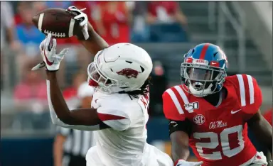  ?? (AP file photo) ?? Arkansas’ Trey Knox (left) and Mike Woods combined to collect 12 catches for 172 yards in a loss at Ole Miss last season. That means nothing for Saturday’s game, Woods said. “So we haven’t made a yard against them this year,” he said. “We still have to go out and earn every yard.”