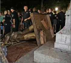  ?? AP Photo/Gerry Broome ?? In this Aug. 20 file photo, police stand guard after the confederat­e statue known as Silent Sam was toppled by protesters on campus at the University of North Carolina in Chapel Hill, N.C.