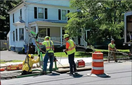  ?? TANIA BARRICKLO — DAILY FREEMAN ?? A worker at the former sinkhole site on Washington Avenue in Kingston, N.Y., is lowered for undergroun­d work on Monday.