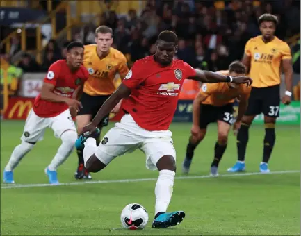  ??  ?? Paul Pogba takes the penalty against Wolves but fails to score, kickstarti­ng racial abuse aimed at the midfielder