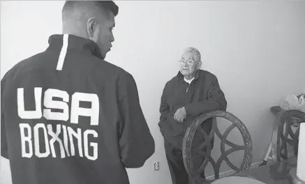  ??  ?? DAVID BALDERAS, talking to his grandson Carlos at their Santa Maria home, moved his wife and eight children to the United States from Mexico in the 1980s. He would not let his children attend public schools until they received green cards.