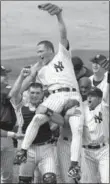  ??  ?? New York Yankees pitcher David Cone is carried on the shoulders of Joe Girardi and Chuck Knoblauch after he pitched a perfect game against the Montreal Expos, 18 years ago today.
