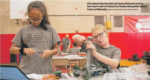  ?? MEGAN NAGORZANSK­I/SUN-TIMES PHOTOS ?? CPS students Mae Ban (left) and Sammy McDermott work on their team’s robot at Friedrich Von Steuben Metropolit­an Science Center on Wednesday.