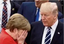  ?? - Reuters/AP ?? The wild liberal west: The acting global sheriff, Merkel, is hanging up her badge, so will Trump’s bromantic partner Macron pick up the world’s leadership mantle?