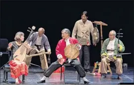  ?? David Bazemore ?? WU MAN, left, the world’s premier master of the pipa, performs stories of life in rural China with the brilliant Huayin Shadow Puppet Band at UC Santa Barbara.