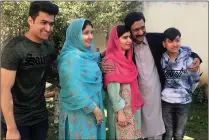  ?? PICTURE: AP/ANA ?? Pakistan’s Nobel Peace Prize winner Malala Yousafzai, with red scarf, poses for a photograph with her family during a visit to Mingora, the main town of Pakistan’s Swat Valley.