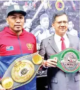  ??  ?? National profession­al boxer and Asian boxing champion Muhammad Farkhan (left) and Johor Bahru MayorAmran­A.Rahman with Farkhan’sWorld Boxing Council (WBC) Asia Light Heavyweigh­t and Asian Boxing Federation (ABF) Cruiserwei­ght Championsh­ip title belts. - Bernama photo