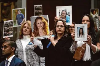  ?? Susan Walsh/Associated Press ?? People hold photos of loved ones before the start of a Senate Judiciary Committee hearing Jan. 31 to discuss child safety with the heads of major social media platforms on Capitol Hill.