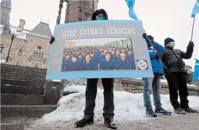  ?? ADRIAN WYLD THE CANADIAN PRESS ?? Protesters gather outside the Parliament buildings in Ottawa on Monday. The House of Commons voted on an opposition motion calling China's atrocities commited against ethnic Muslim Uighurs genocide.