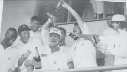  ?? ?? The England team celebrate their astonishin­g victory, dousing Man-of-the-Match Alec Stewart with Tetley Bitter, their sponsor’s brew. Stewart, champagne in hand, is flanked by (left to right, front row) Chris Lewis, Skipper Mike Atherton, Robin Smith and Jack Russell. Tetley Bitter sponsored England’s cricket team from 1994 to 1998. (Photo from Caribbean Red Stripe Cricket Quarterly, Vol # 4, Issue # 3, July/September 1994)