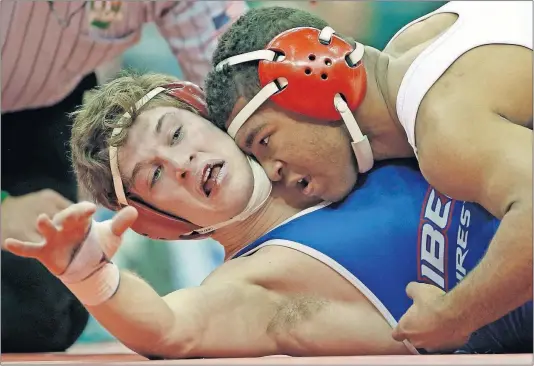  ?? [KYLE ROBERTSON/DISPATCH] ?? Dom Demas of Dublin Coffman takes down Trey Grenier of Olentangy Liberty during the 145-pound final at Value City Arena.