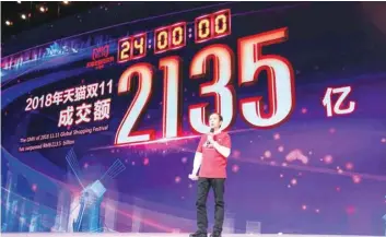  ?? — AFP ?? Alibaba CEO Daniel Zhang speaks in front of a screen showing total sales at over 213.5 billion yuan ($30.7 billion) shortly after the end of the Double 11, or ‘Singles Day’ shopping festival in Shanghai