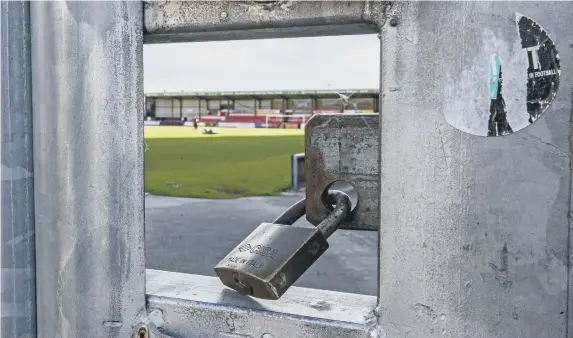  ??  ?? Locked gates have been a common theme for non-league clubs this year. Photo by Peter Byrne/PA Wire