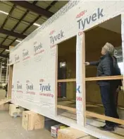  ?? CLAIRE RUSH/AP ?? Oregon Gov. Tina Kotek looks at a mass timber affordable housing prototype, seen as a possible solution to homelessne­ss, at the Port of Portland.