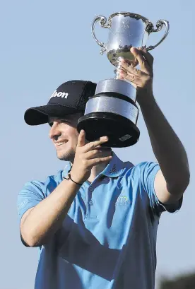  ?? Picture: AFP ?? REIGNING SUPREME. Scotland’s David Law with the trophy after winning the Vic Open at the 13th Beach Golf Links at Barwon Heads near Melbourne yesterday.