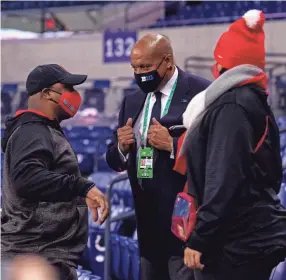  ?? DOUG MCSCHOOLER, USA TODAY SPORTS ?? Big Ten Conference commission­er Kevin Warren visits with fans in the stands before the start of the Big Ten Championsh­ip game between Ohio State and Northweste­rn at Lucas Oil Stadium.