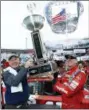  ?? WADE PAYNE — THE ASSOCIATED PRESS ?? Food City president and CEO, Steve Smith, left, holds the trophy with race winner Kyle Busch after a NASCAR Cup Series auto race, Monday in Bristol, Tenn.