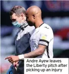  ??  ?? Andre Ayew leaves the Liberty pitch after picking up an injury