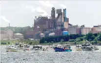  ?? ANDREW VAUGHAN/THE CANADIAN PRESS FILES ?? Fishing boats pass the Northern Pulp mill in July as residents, Indigenous groups and fishermen protest the mill’s plan to dump effluent into the Northumber­land Strait.