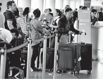  ?? MARK BOSTER/TRIBUNE NEWS SERVICE ?? Long lines at the airport are a drag, but a little bit of money can help make them shorter or disappear completely.