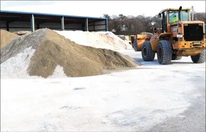  ?? Photos by Ernest A. Brown ?? Above, the Woonsocket Highway garage on River Street was a hub of activity as workers took delivery of a new supply of salt and sand just in time for the forecast evening snowfall, the first of the season and a month earlier than last year. Below, the plows were out in Woonsocket for an early-December snowstorm last year, which dumped over 8 inches in the region and prompted a Winter Storm Warning. Not as much snow is being forecast with this storm, but the first one of the season always seems to take even the heartiest of New Englanders by surprise.