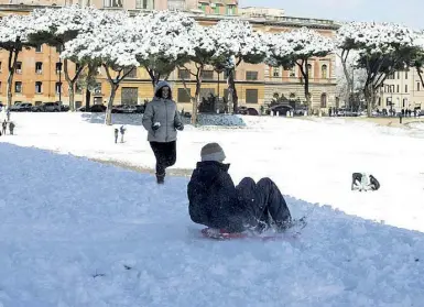  ??  ?? Circo Massimo Molti romani e turisti, armati di slittino e addirittur­a di sci, hanno solcato i prati ricoperti di neve davanti al Palatino (foto LaPresse). A sinistra l’ironica cartina che trasforma la zona Nord della città in impianti di risalita