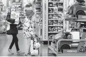  ??  ?? Sisters Emma, 5, left, and Elena Perez-Liska, 4, check out Walmart’s holiday toy selection.