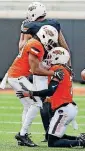  ?? [PHOTO BY NATE BILLINGS, ?? Bryce Brown, left, helps up Ramon Richards after Richards broke up a pass during the spring football game in April. Richards has made the move from cornerback to safety.