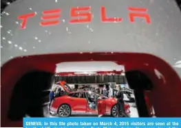  ??  ?? GENEVA: In this file photo taken on March 4, 2015 visitors are seen at the booth of US electric carmaker Tesla Motors, during the press day of the Geneva Car Show. — AFP