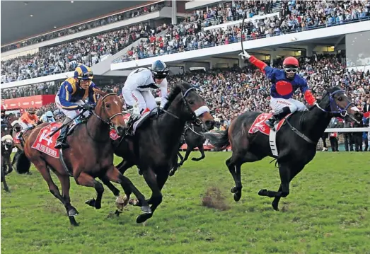  ?? Picture: JACKIE CLAUSEN ?? VICTORY BEAT: Jockey Smanga Khumalo, right, boots home Heavy Metal in yesterday’s Vodacom Durban July