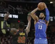  ?? TONY DEJAK — THE ASSOCIATED PRESS ?? Oklahoma City Thunder’s Paul George (13) shoots over Cleveland Cavaliers’ Jeff Green (32) in the second half of an NBA basketball game, Saturday, Jan. 20, 2018, in Cleveland.