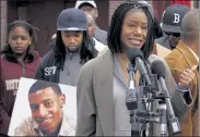  ?? STEVEN SENNE / AP ?? Thulani DeMarsay, right, aunt of Danroy ‘DJ’ Henry Jr., who was shot and killed by a police officer, speaks as Henry's uncle Jamele Dozier, left, holds a photograph of Henry during a news conference in Boston's Roxbury neighborho­od.