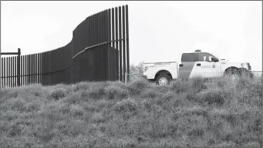  ?? AP/ERIC GAY ?? A U.S. Customs and Border Patrol agent passes along a section of border wall Nov. 13 in Hidalgo, Texas.