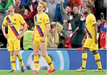  ?? AFP ?? (from left) Barcelona’s Spanish midfielder Sergi Roberto, Dutch midfielder Frenkie de Jong and French defender Samuel Umtiti react after Athletic Bilbao’s Spanish forward Inaki Williams scored in their Spanish Copa del Rey (Kings Cup) quarterfin­al at the San Mames stadium in Bilbao on Thursday. —