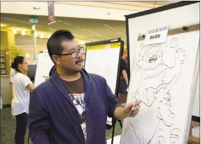  ??  ?? Artist Ben Seto makes a drawing at the Santa Clara Library Comic Con on Saturday. The event featured panels and workshops from special guests, and activities like virtual reality gaming, anime showings and hands-on crafts for all ages.