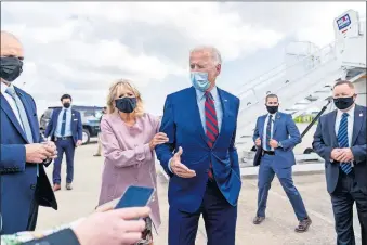  ?? [ANDREW HARNIK/ASSOCIATED PRESS FILE PHOTO] ?? In this Oct. 5 photo, Jill Biden moves her husband, Democratic presidenti­al candidate former Vice President Joe Biden, back from members of the media as he speaks outside his campaign plane at New Castle Airport in New Castle, Del., to travel to Miami for campaign events.