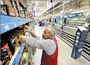  ?? AP ?? Sales associate Larry Wardford stocks shelves recently at a Lowe’s home improvemen­t store in Framingham, Mass. So far, U.S. shopping in 2018 has been lackluster.