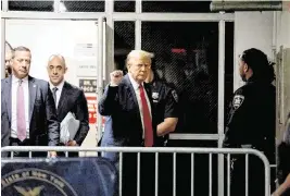  ?? JEFFERSON SIEGEL NYT ?? Former President Donald Trump raises a fist outside the courtroom as he returns from lunch Thursday in his criminal trial at Manhattan Criminal Court in Manhattan.