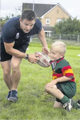  ??  ?? Ball boy This youngster had a great time playing rugby at the Cambuslang RFC Hero Day