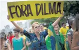  ?? Pictures / AP ?? Brazilians march in Rio de Janeiro calling for the impeachmen­t of Dilma Rousseff, including a woman with a sign that says “Dilma Out” in Portuguese.