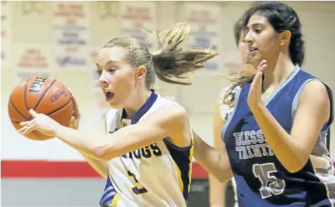  ?? JULIE JOCSAK/STANDARD STAFF ?? Lauren Vanecko of the Sir Winston Churchill Bulldogs keeps the ball away from Kayla Staios of the Blessed Trinity Thunder during the Standard Girls Basketball Tournament at Governor Simcoe in St. Catharines on Thursday.