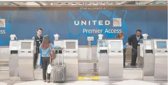  ?? SCOTT OLSON/GETTY IMAGES FILE ?? A passenger checks in at the United Airlines terminal at O’Hare Airport last year.