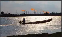  ?? ?? A man near the Nihran Bin Omar oil field north of Basra, Iraq, Wednesday, March 22, 2023. In the wake of the US invasion of Iraq in 2003 and toppling of Saddam Hussein, foreign investors flocked to the country’s abundant oil fields and contracts were doled out, filling Iraqi state coffers. The new constituti­on drafted in 2005 states that the country’s oil wealth belongs to the Iraqi people. (AP)