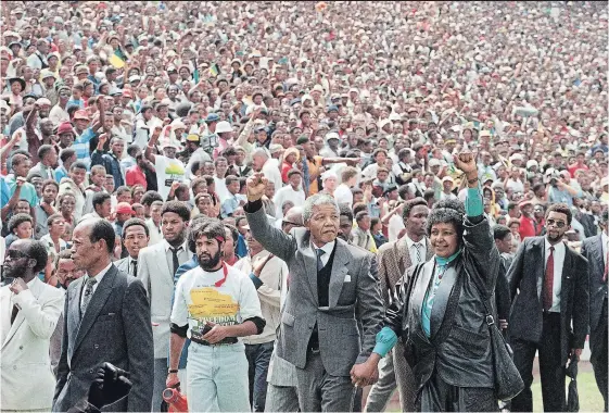  ?? UDO WEITZ AP FILE PHOTO ?? Feb. 13, 1990: Nelson Mandela and Winnie Mandela give black power salutes as they enter the Soccer City stadium in the Soweto township of Johannesbu­rg shortly after his release from 27 years in prison. The centennial of Mandela’s birth is July 18, and...