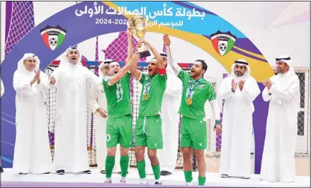  ?? ?? Al-Arabi players celebrate with the championsh­ip trophy.