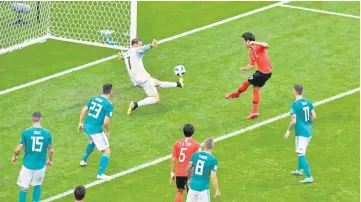  ??  ?? South Korea’s Kim Young-gwon scores against Germany at Kazan Arena in Kazan, Russia. — Reuters photo